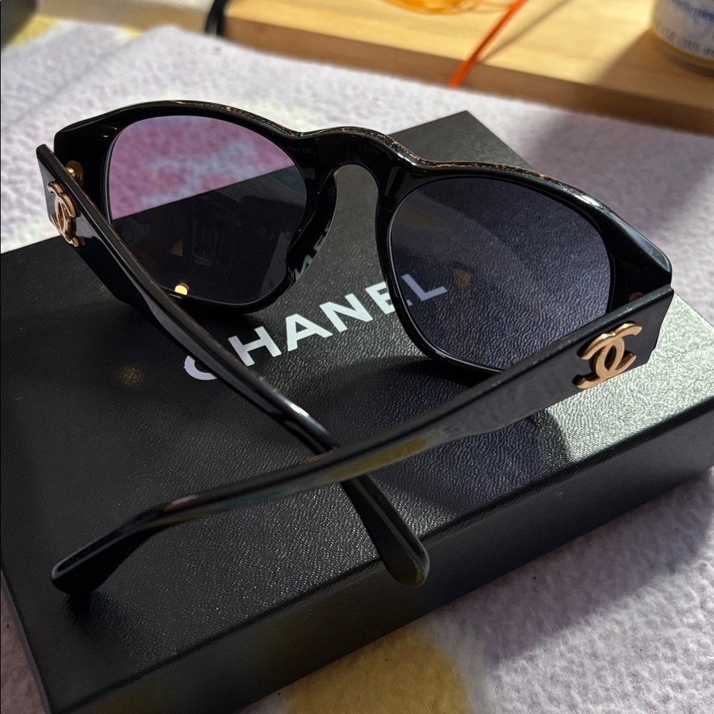 Reselling:  CHANEL Black Sunglasses with Gold Accents